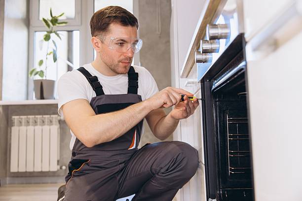 Technician working on a wall oven